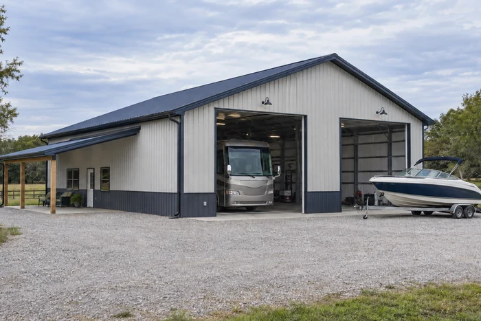 Tall-door storage building with a motorhome and a boat on a trailer.