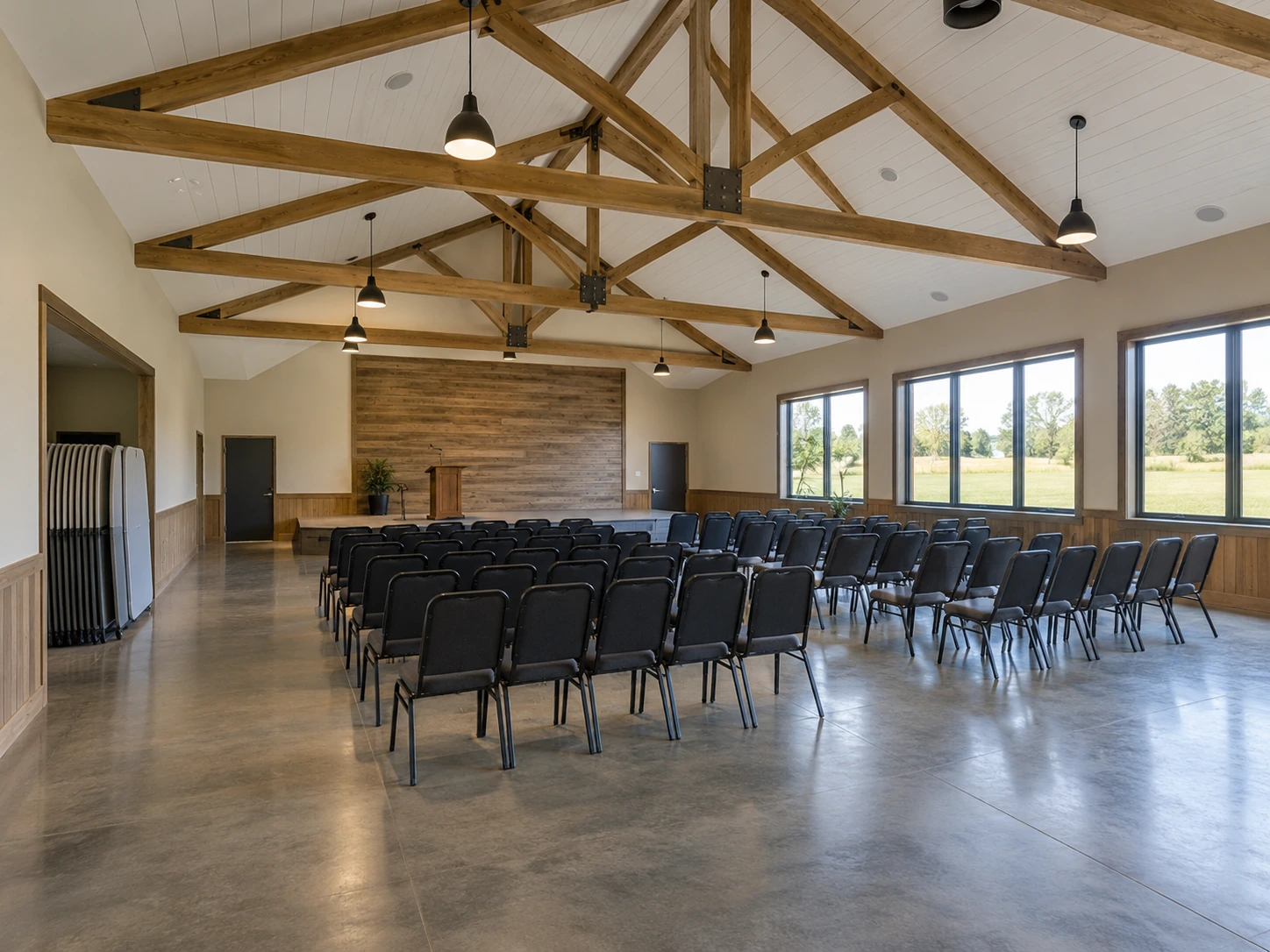 Finished community hall with flexible seating and clear circulation aisles. Finished community hall with flexible seating and clear circulation aisles.